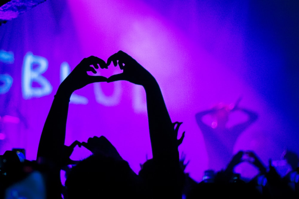 silhouette of person raising hands