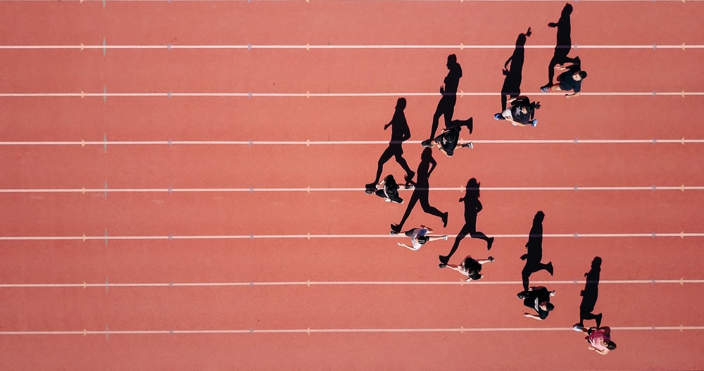 group of people running on stadium