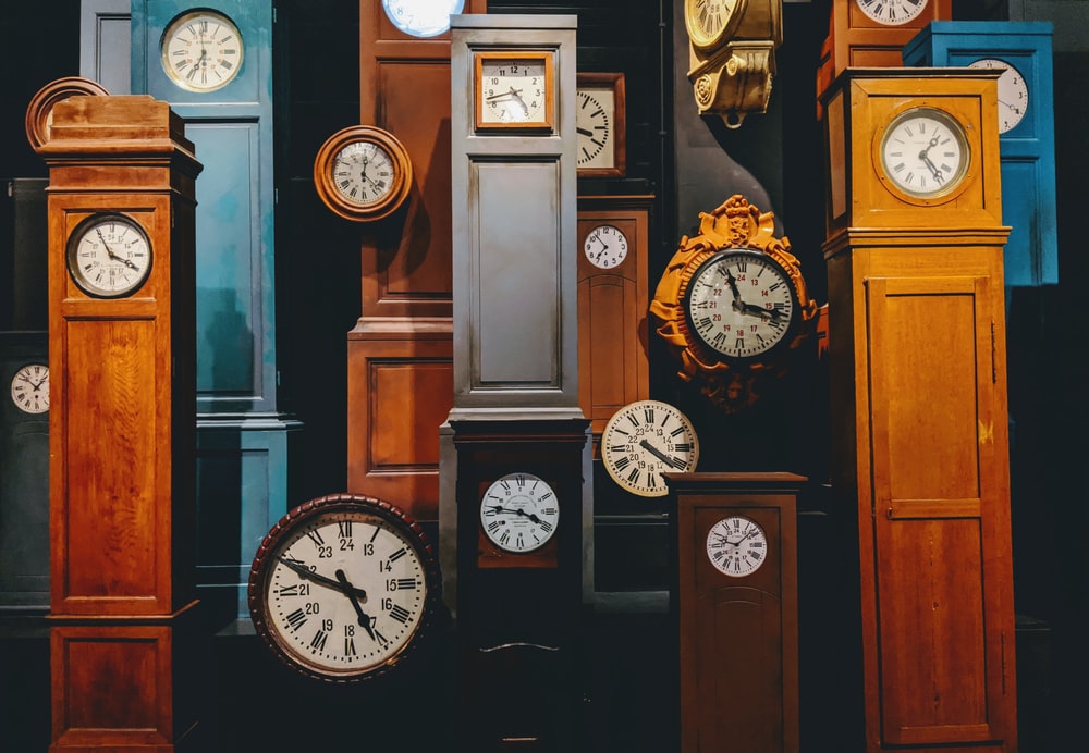 brown wooden framed analog clock