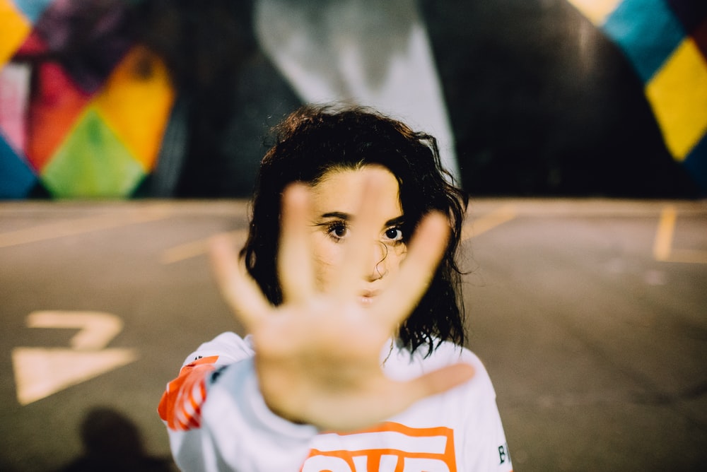 woman wearing white and orange top