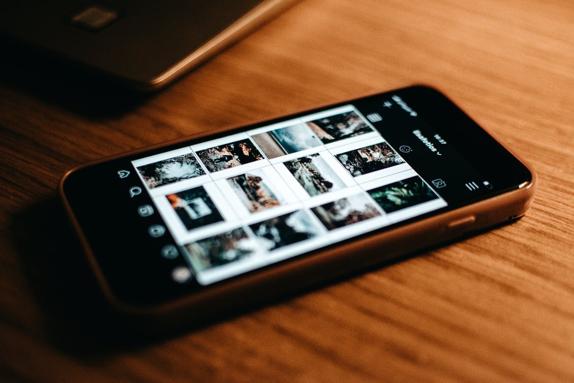 Black Iphone 4 on Brown Wooden Table