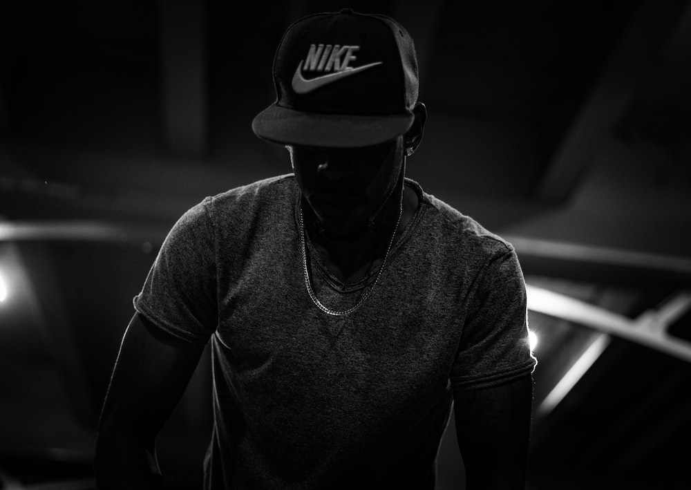 silhouette photo of man in Nike cap